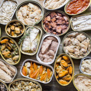 Assortment of cans of canned with different types of fish and seafood,